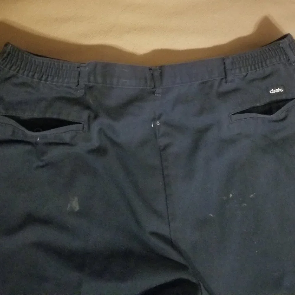 Three stained Cintas men's pants with stretching waistbands